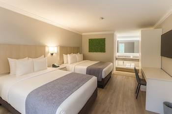 Double Room, 2 Queen Beds, Non Smoking | In-room safe, desk, laptop workspace, blackout drapes at Orlando International Drive North Hotel