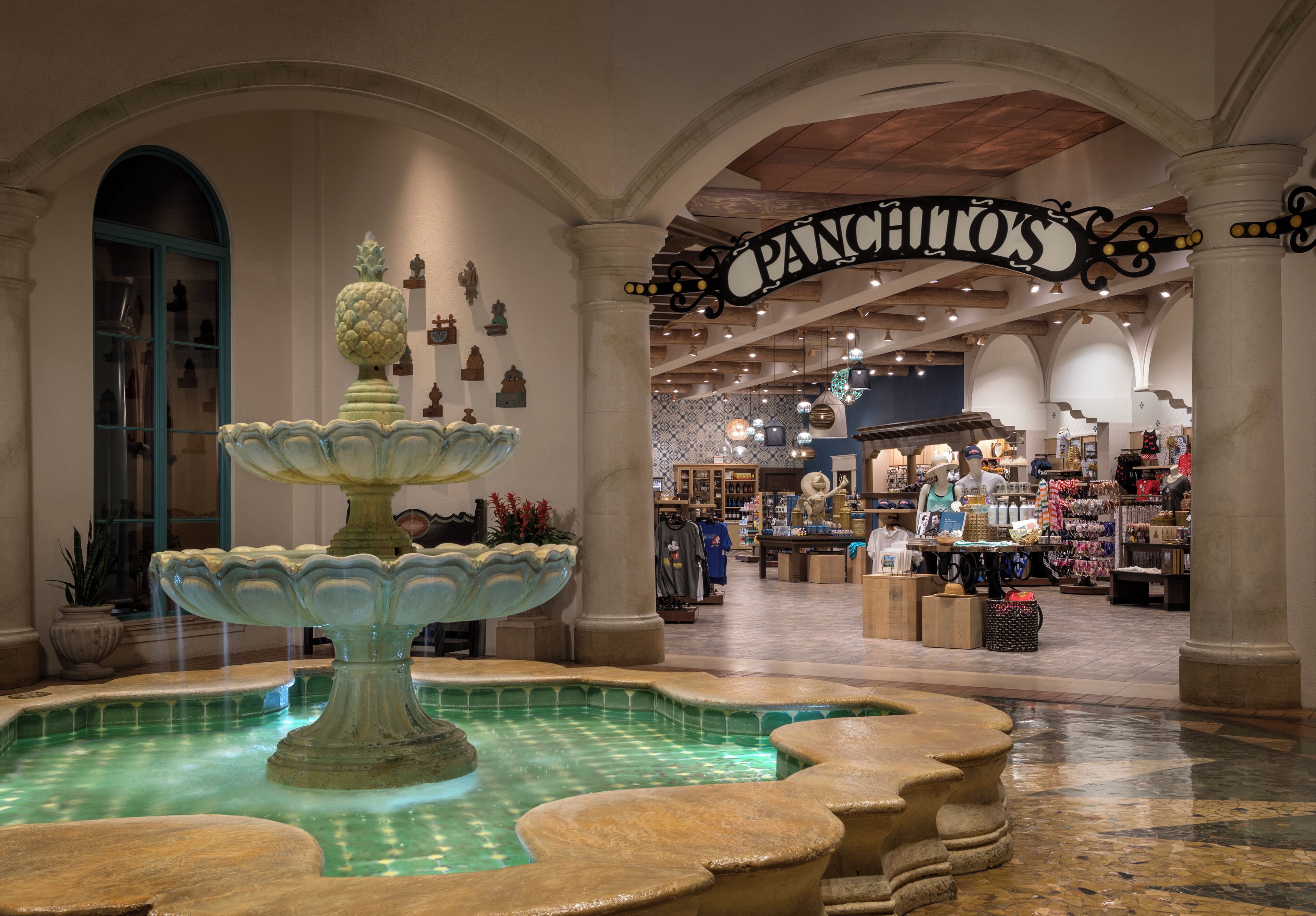 A spacious atrium with a central fountain, a 'PANCHITOS' sign, and a variety of shops in the background.