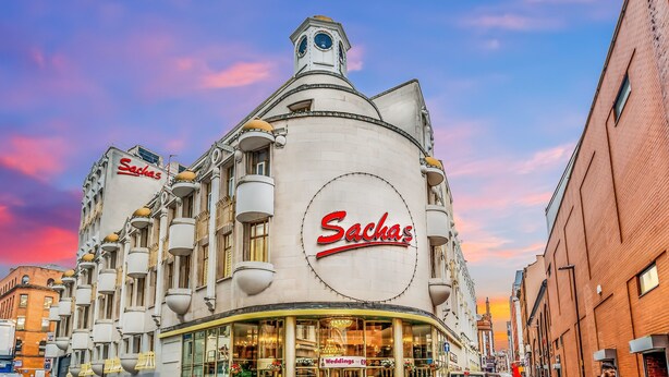 A building with a large circular sign reading "Sachas" and a smaller sign for "Weddings" below it. - Britannia Sachas Hotel (Manchester)