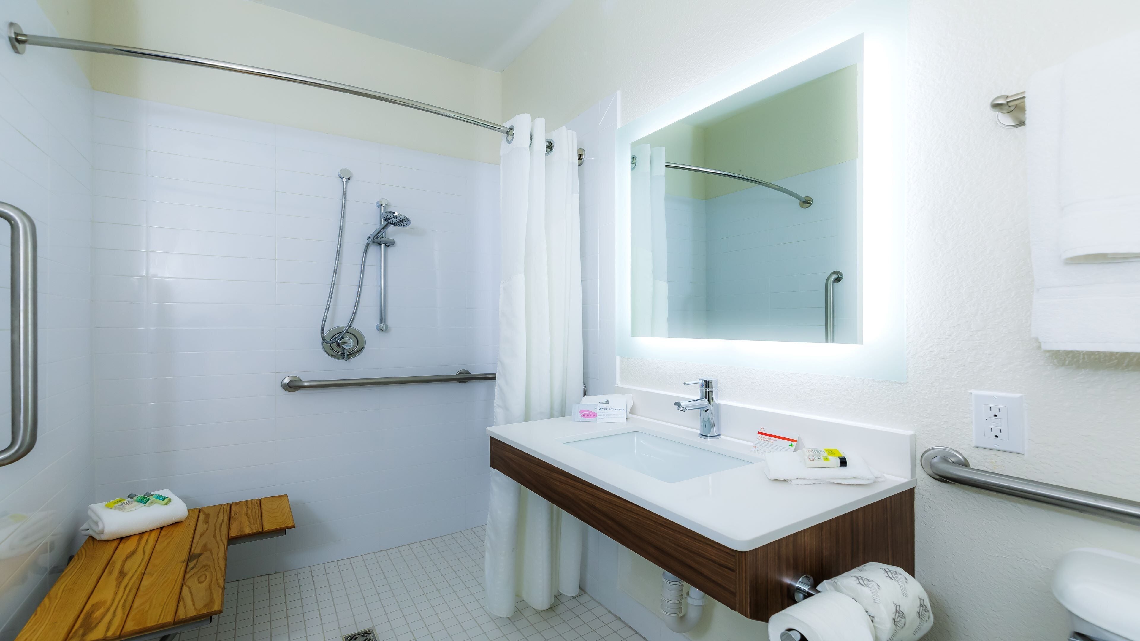 A bathroom with a shower, toilet, and sink.
