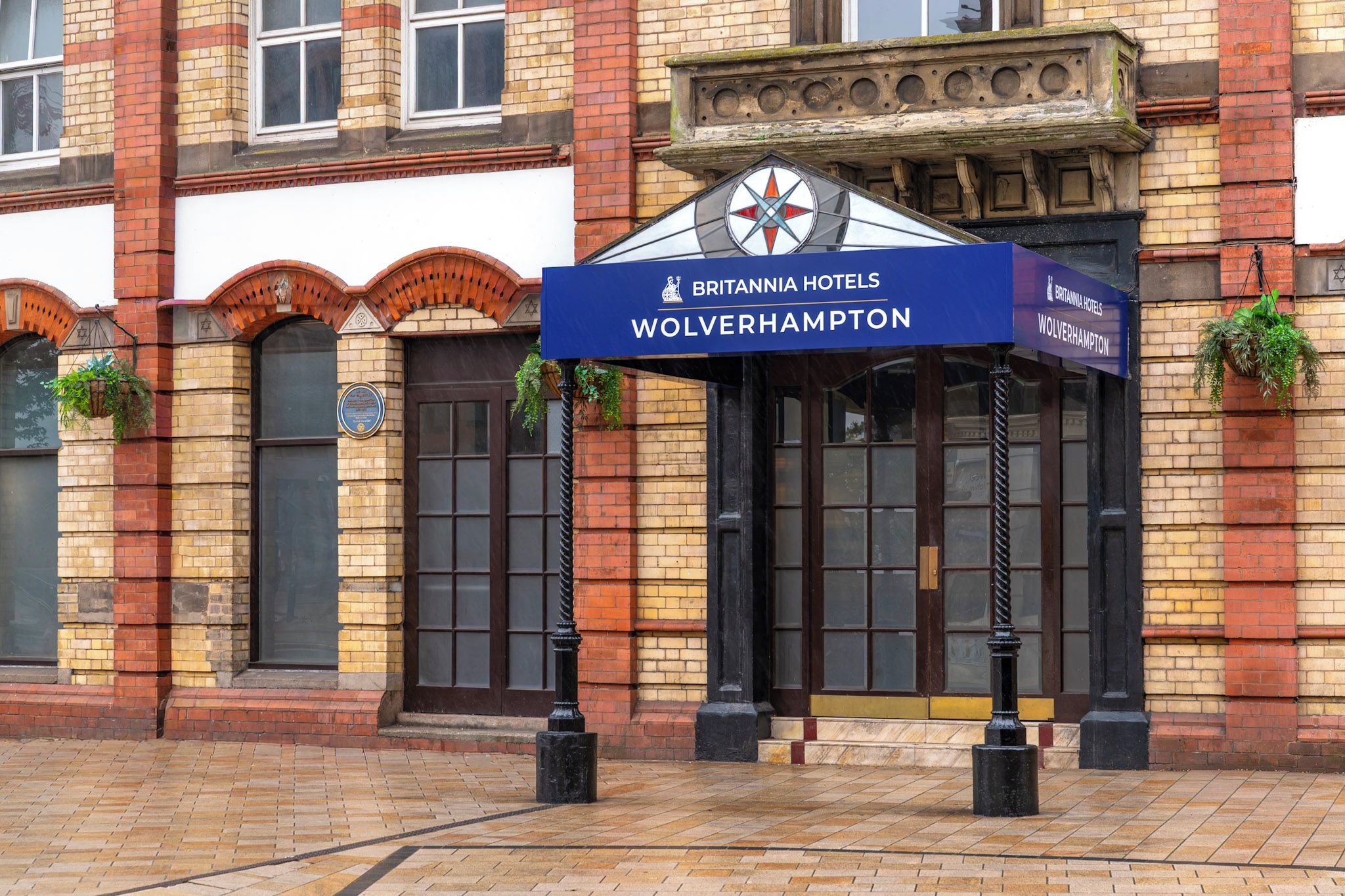 A brick building with a sign for Britannia Hotels in Wolverhampton.
