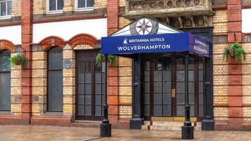 A brick building with a sign for Britannia Hotels in Wolverhampton.