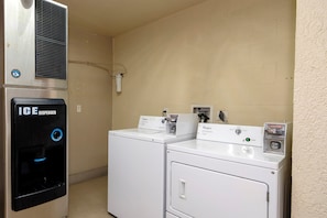 A laundry facility with an ice dispenser and two Whirlpool washing machines. - Red Roof Inn Ellenton – Bradenton NE (Ellenton)