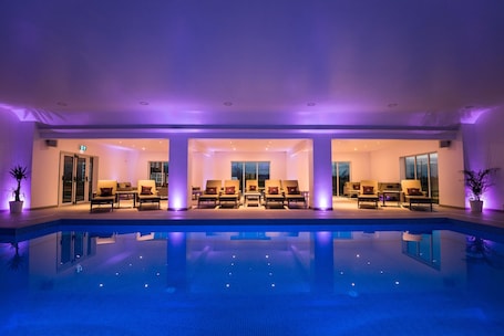 A poolside area with lounge chairs and a pool.