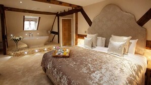 A bedroom with a large bed, a bathtub, and a wooden ceiling structure. - Worcester Bank House Hotel Spa & Golf, BW Premier Collection (Worcester)