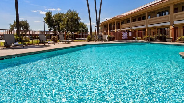 Seasonal outdoor pool, open 10:00 AM to 10:00 PM, pool loungers