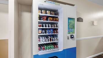 A vending machine stocked with snacks and drinks, labeled "medibox" and "pharmacy pickup."
