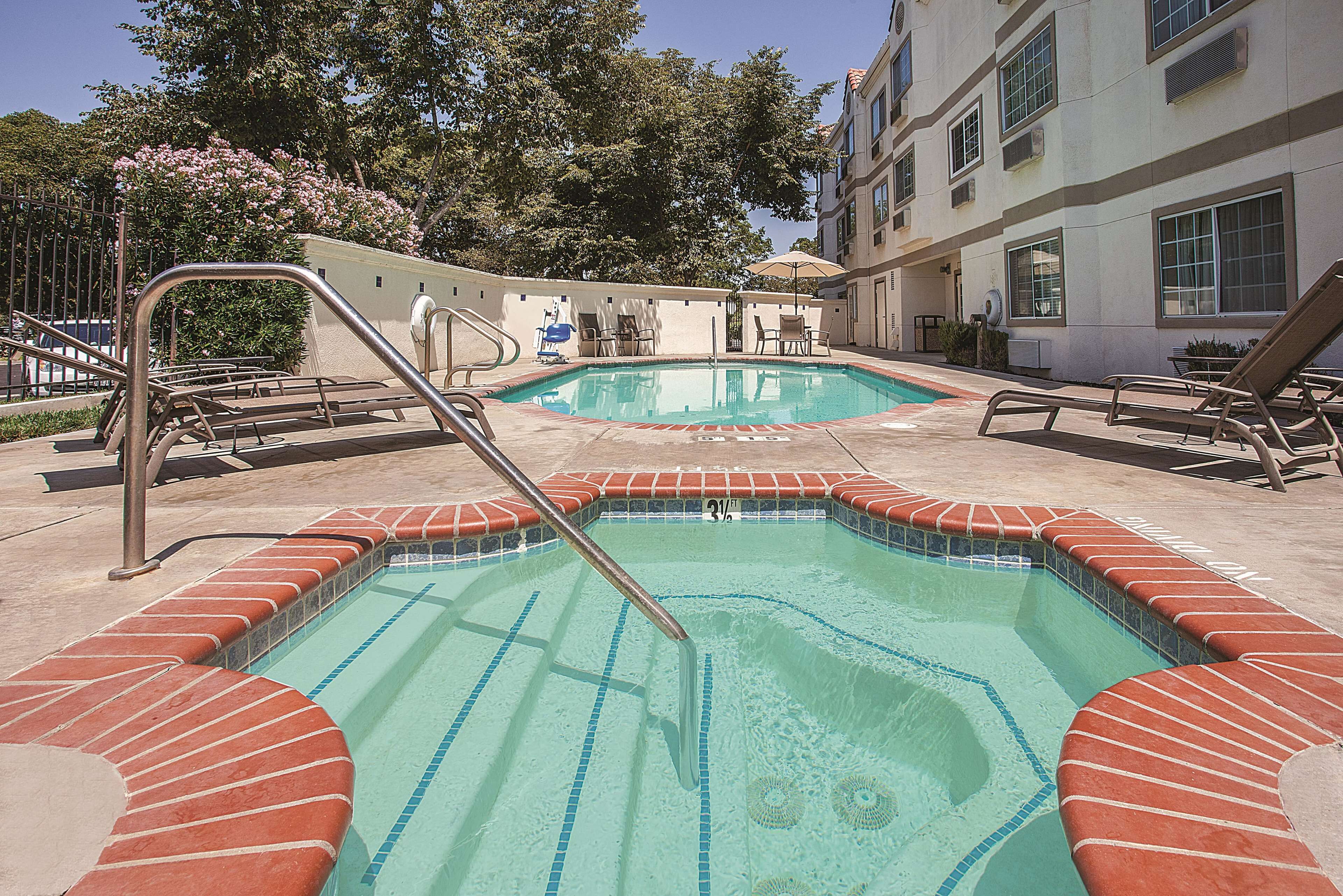 Outdoor pool, open 10:00 AM to 10:00 PM, pool loungers