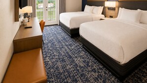 A hotel room with two beds, a desk, a chair, a TV, and a view of the outdoors. - Best Western Plus Atlanta Sandy Springs Perimeter Hotel (Atlanta)