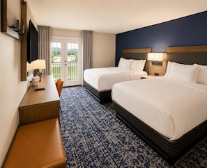 A hotel room with two beds, a desk, a chair, a TV, and a view of the outdoors. - Best Western Plus Atlanta Sandy Springs Perimeter Hotel (Atlanta)