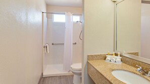 A bathroom with a shower, toilet, and sink. - Days Inn by Wyndham Chowchilla Gateway to Yosemite (Chowchilla)