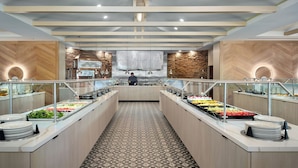A buffet area with multiple food stations, a chef, and a patterned floor. - Emory Conference Center Hotel (Atlanta)