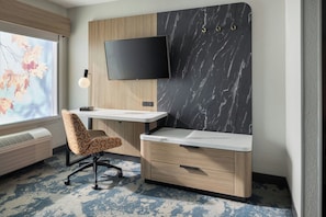 A modern office space with a desk, chair, TV, and air conditioning unit. - Fairfield Inn & Suites by Marriott Atlanta Vinings/Galleria (Atlanta)