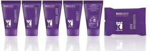 A row of five purple tubes labeled with various skincare products from BasicEarth.