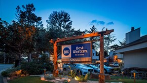 A Best Western Inn & Suites sign at Pacific Grove, surrounded by trees and a parking area. - Best Western The Inn & Suites Pacific Grove (Pacific Grove)