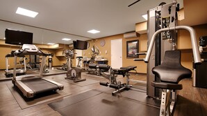 A gym with treadmills, elliptical machines, and weight equipment. - Best Western The Inn & Suites Pacific Grove (Pacific Grove)