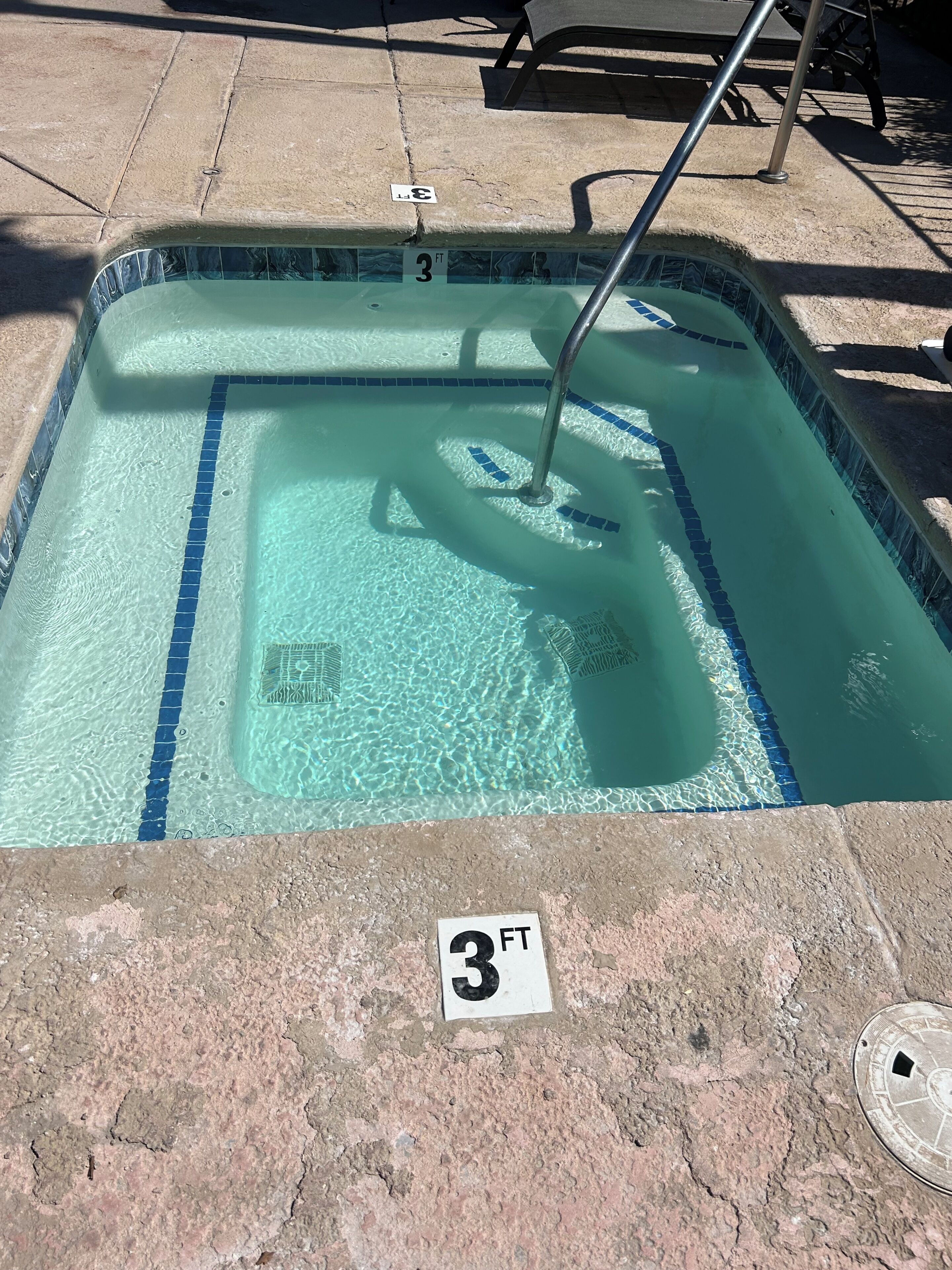 A 3-foot pool with clear water and blue tiles.