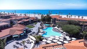 A resort with a swimming pool, beach view, and multiple lounge areas. - Zachari Dunes on Mandalay Beach, Curio Collection by Hilton (Oxnard)