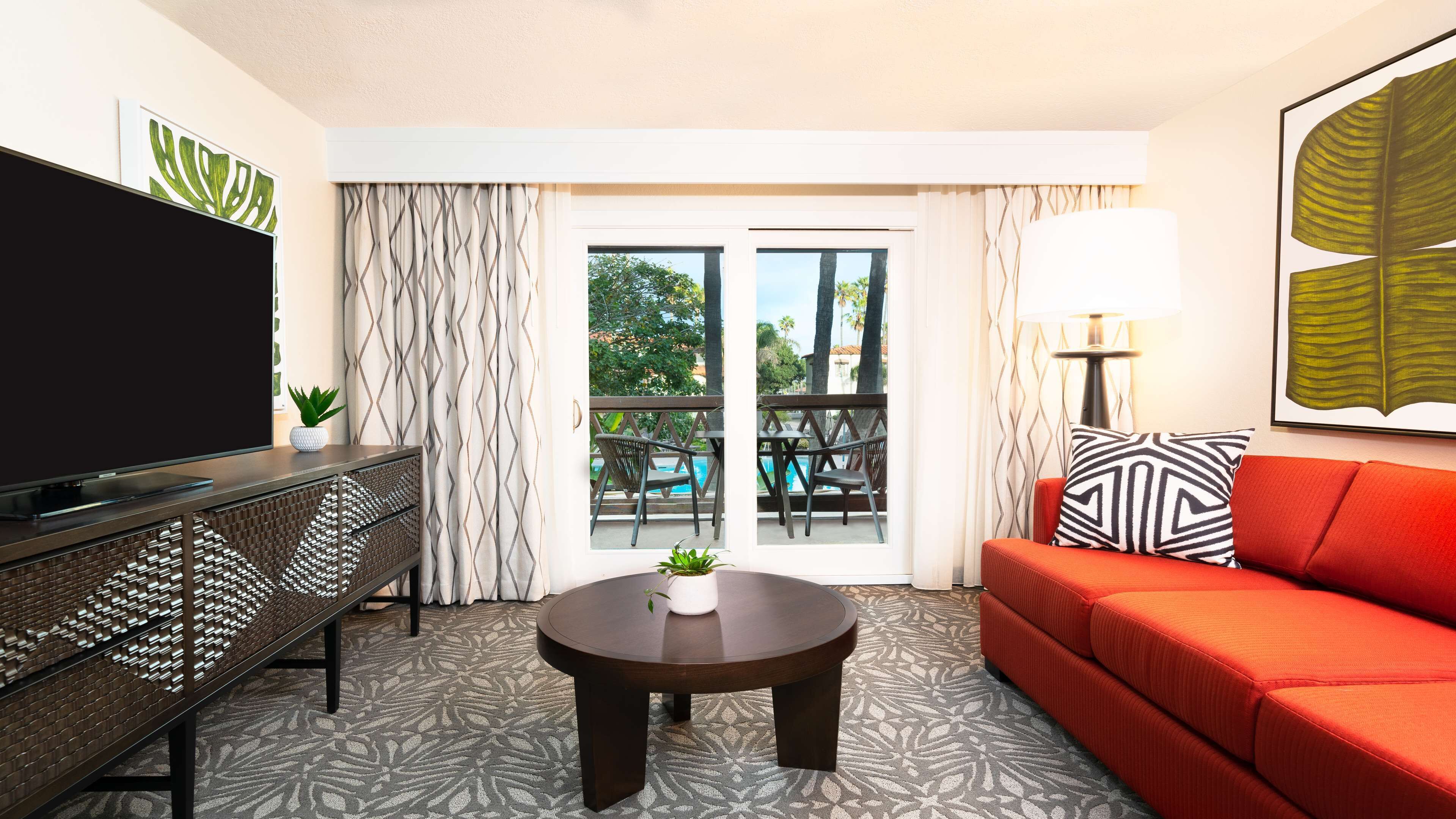 Suite, 1 King Bed, Pool View | Living area | 55-inch TV with cable channels