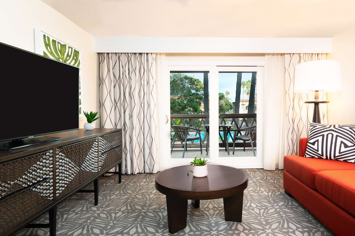 Suite, 1 King Bed, Pool View | Living area | 55-inch TV with cable channels