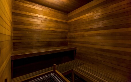 A sauna with wooden walls and benches.