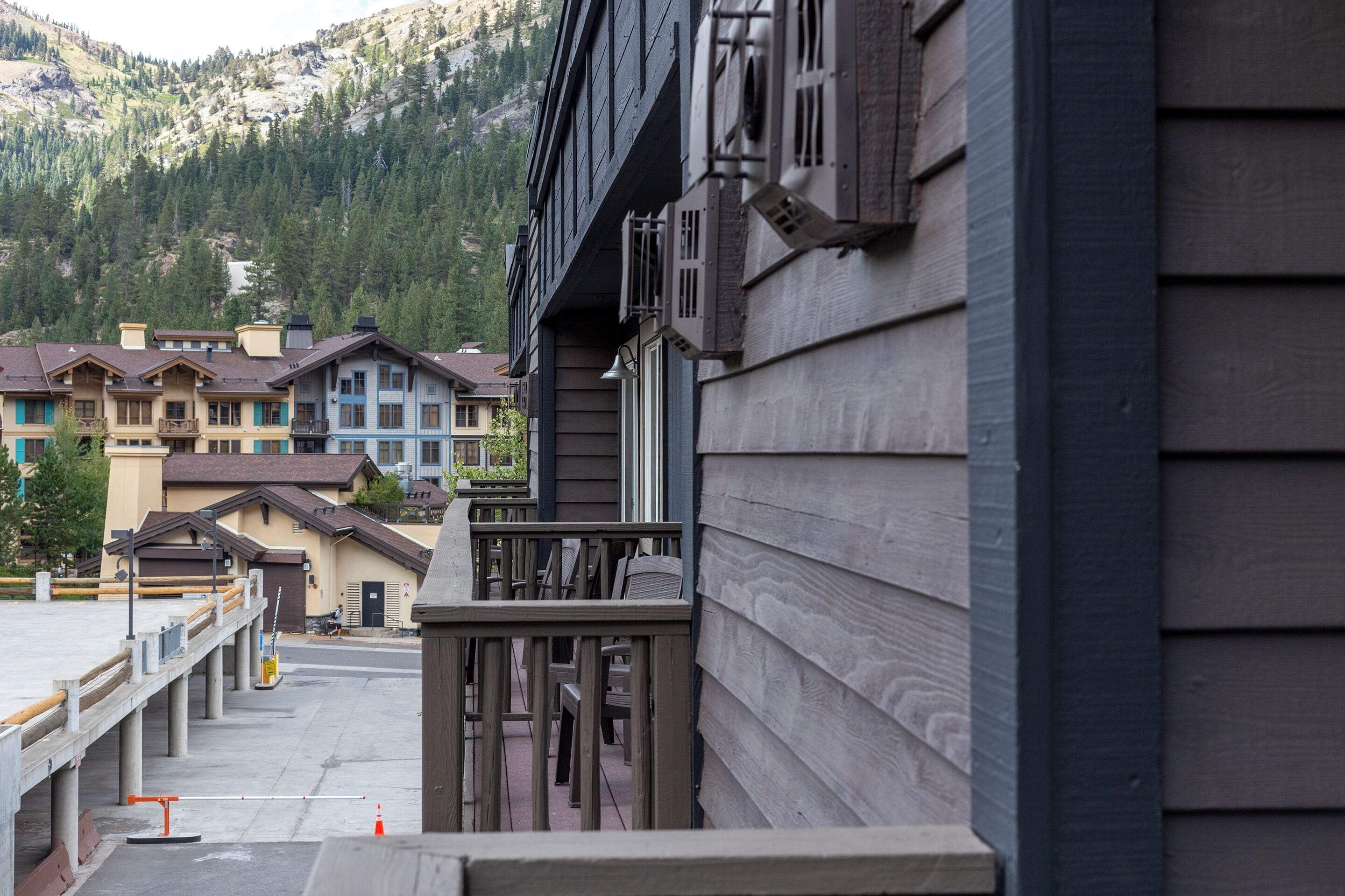 A hotel with a balcony overlooking a mountain.