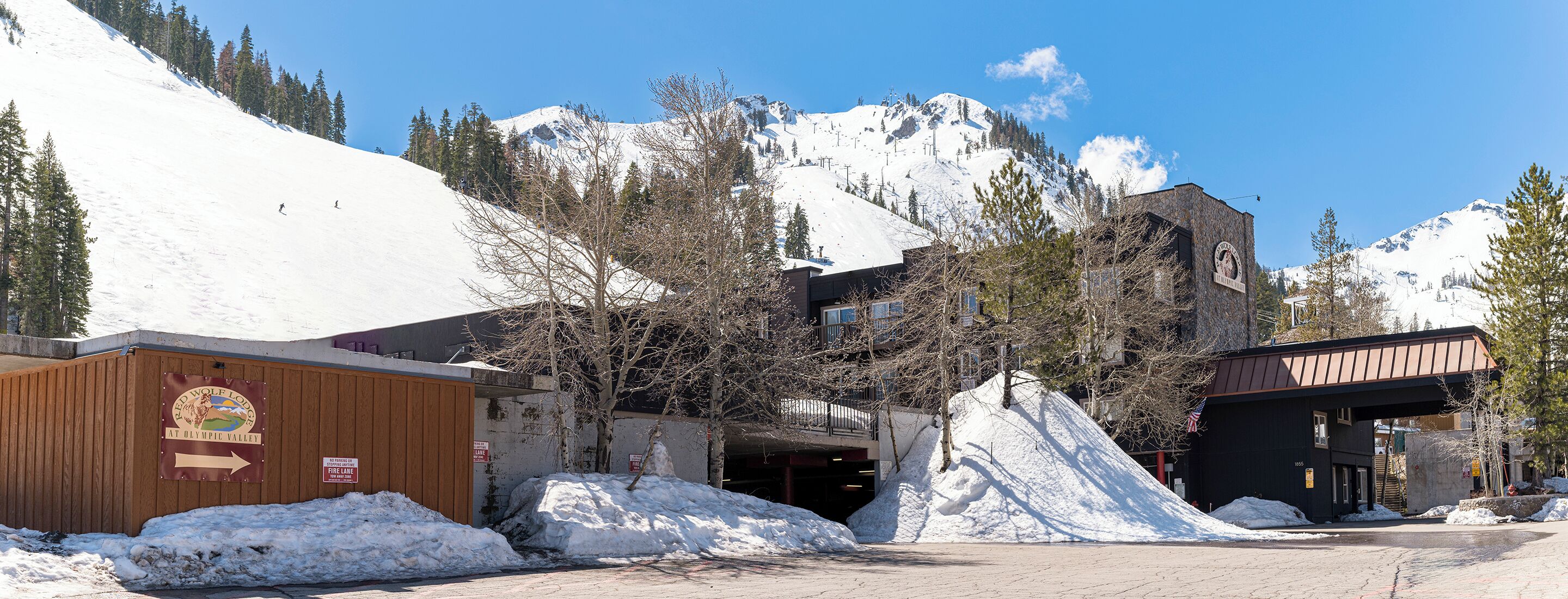 Un edificio con un letrero que indica una zona de acceso restringido para bomberos y el Red Wolf Lodge en Olympic Valley.