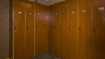 A row of wooden lockers with numbered labels.