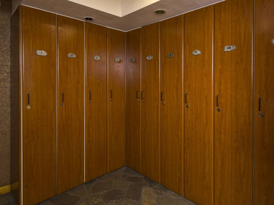 A row of wooden lockers with numbered labels.