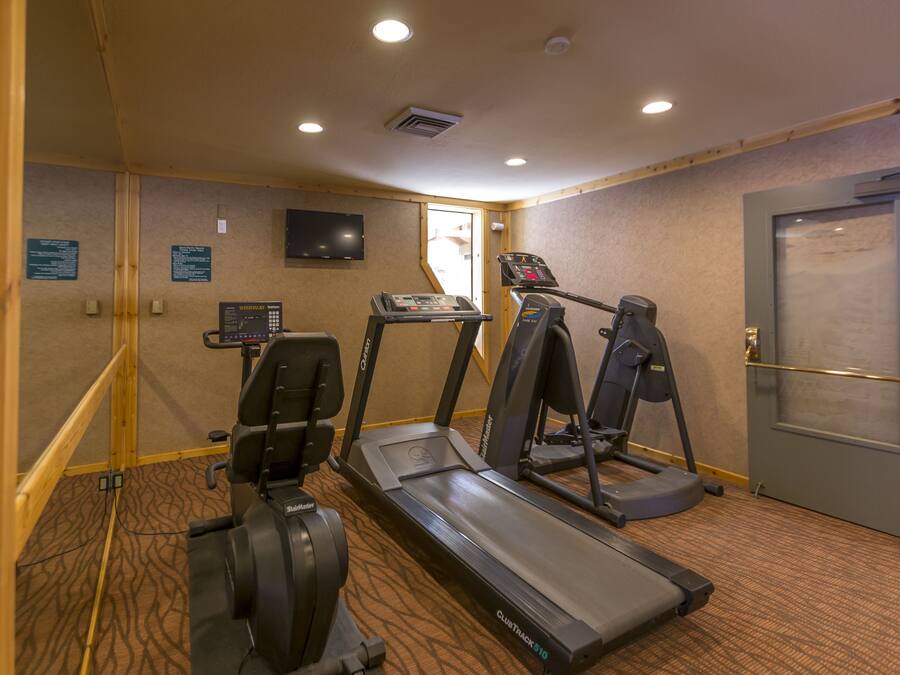 A gym with treadmills, a stationary bike, and a weight machine.