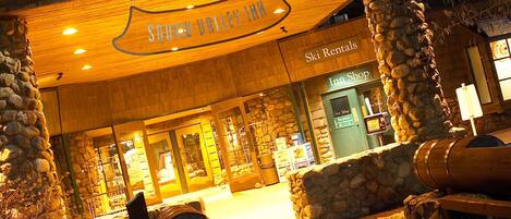 A wooden building with a sign reading "Bar Plumjack" and "Ski Rentals" below.