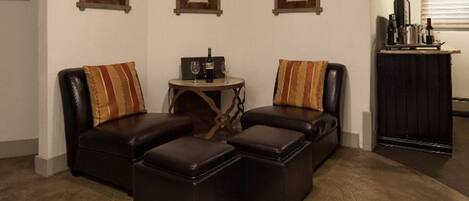 A living room with two leather sofas, a coffee table, and a cabinet.