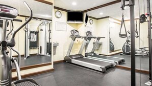 A gym with treadmills, a stationary bike, and a weight machine. - Quality Inn San Diego I-5 Naval Base (San Diego)