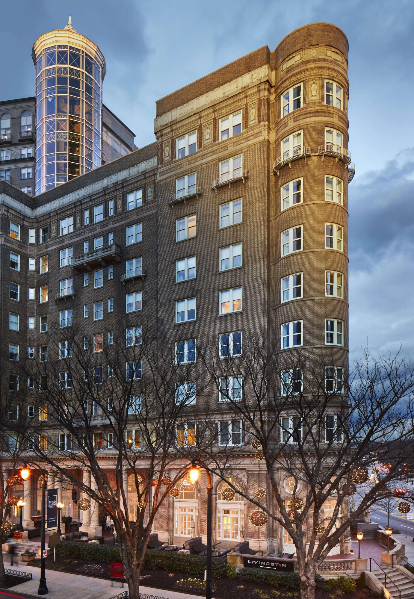 Historic brick facade of Georgian Terrace with Livingston restaurant sign at night