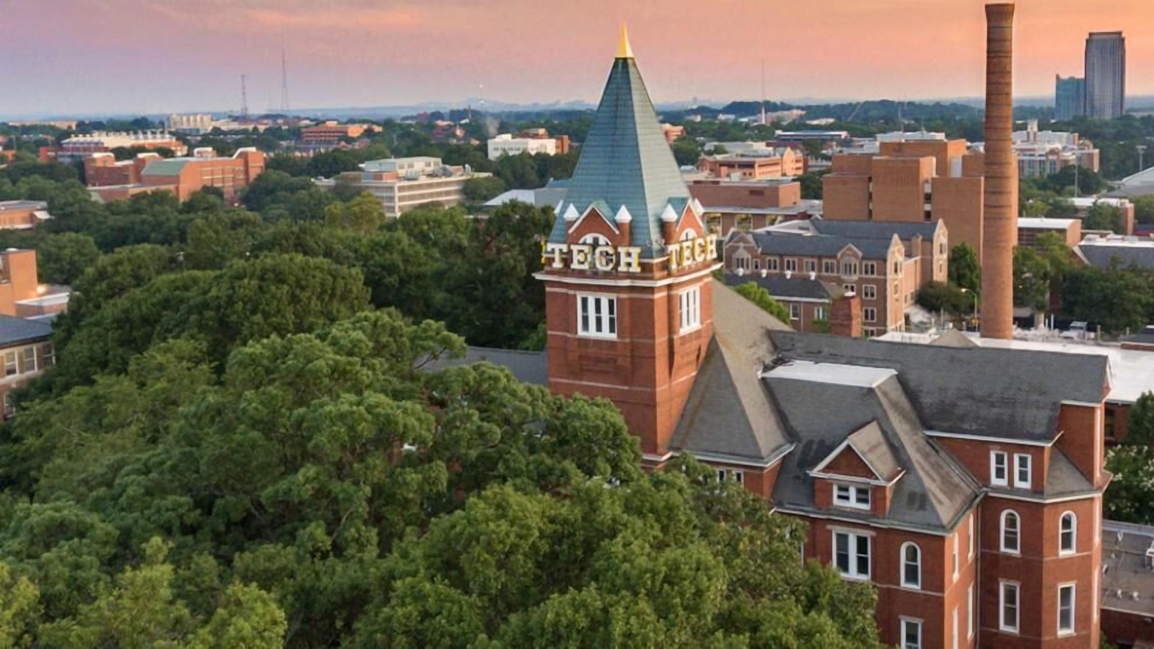 A red brick building with a tower labeled "TECH TECH" and a green roof.