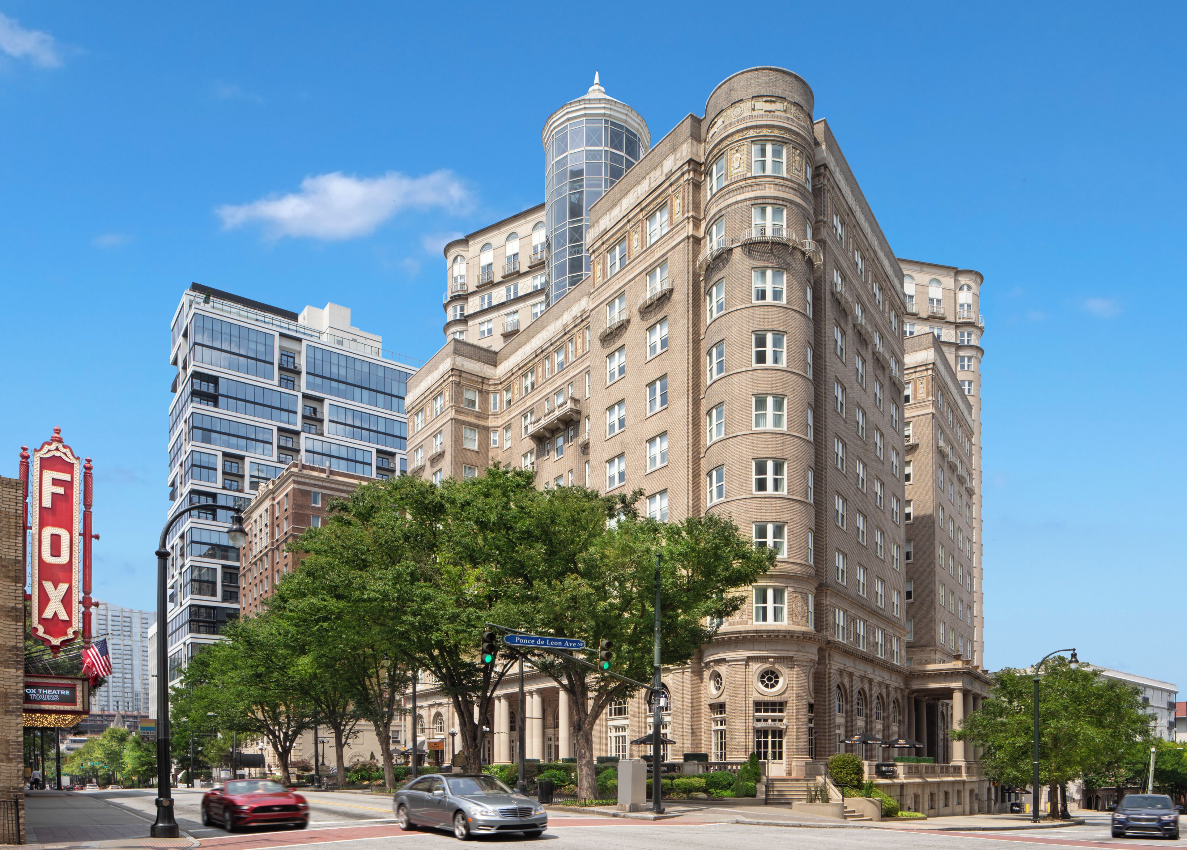 A historic building with a corner entrance, large windows, and a prominent dome structure.