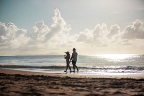 On the beach, white sand, beach cabanas, sun-loungers