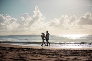 On the beach, white sand, beach cabanas, sun-loungers