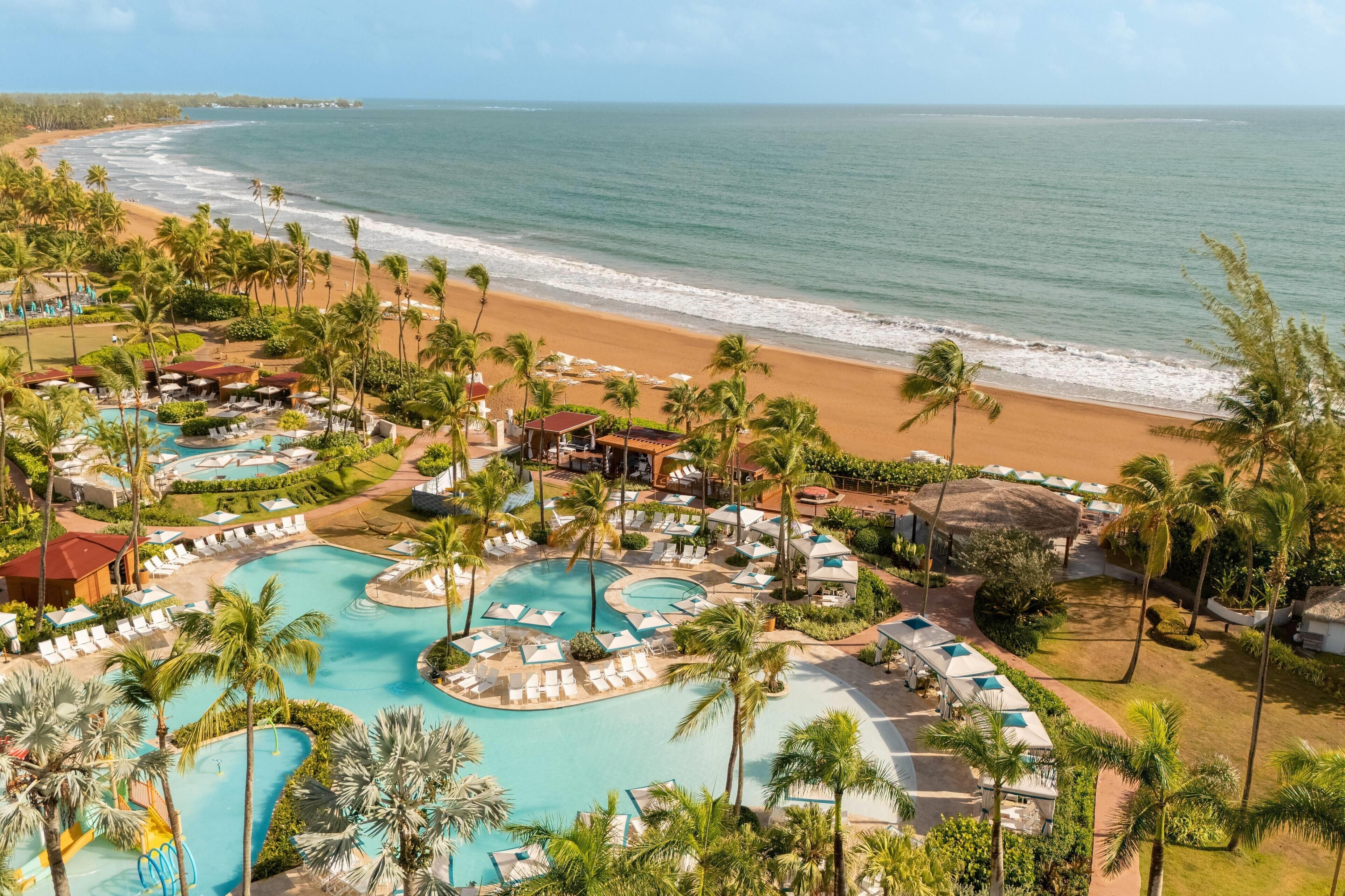On the beach, white sand, beach cabanas, sun-loungers