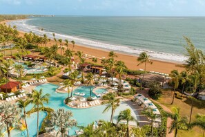 On the beach, white sand, beach cabanas, sun loungers