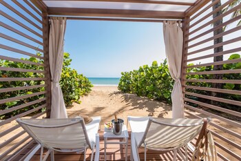 On the beach, white sand, free beach shuttle, beach cabanas at Wyndham Grand Rio Mar Rainforest Beach and Golf Resort