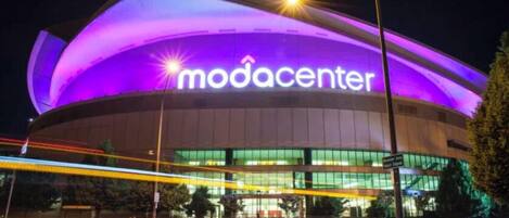 A modern building with a large illuminated sign reading "modacenter".