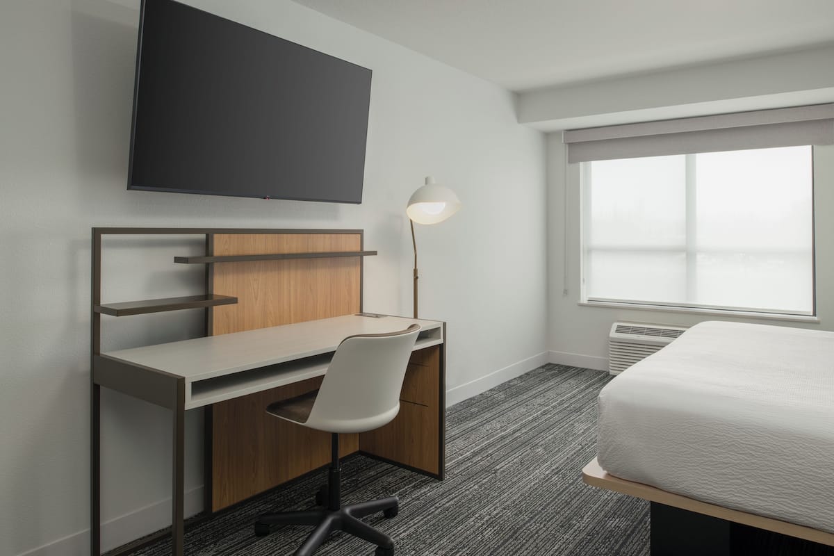 Desk, laptop workspace, blackout drapes, iron/ironing board