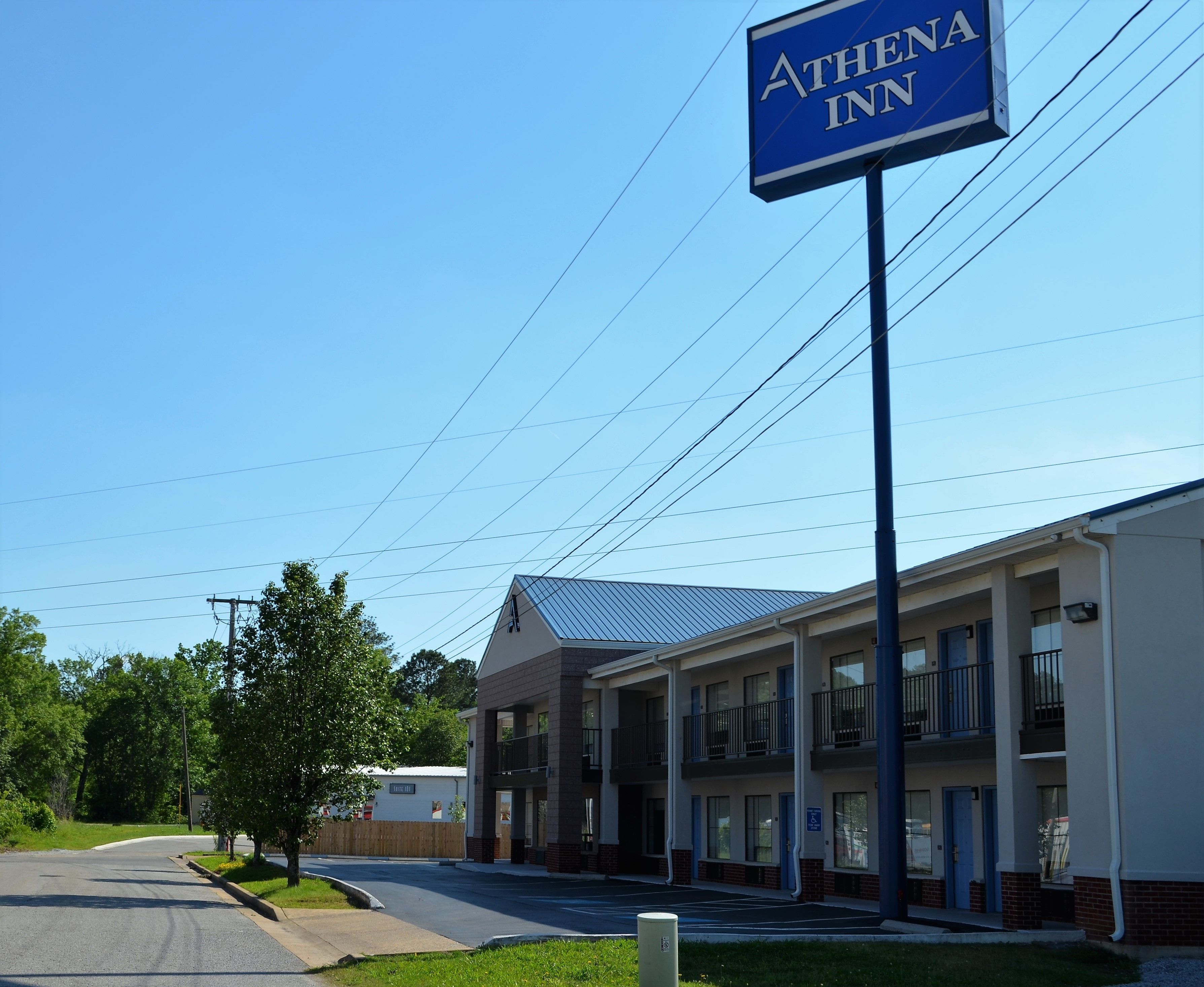 A two-story building with a sign reading "Athena Inn."