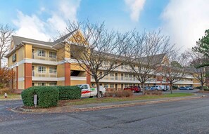 Situated in a suburban setting, this hotel features a two-story structure with a flat roof and a balcony on the upper floor.