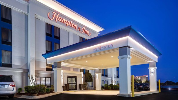 A Hampton Inn hotel with a well-lit entrance and a covered outdoor area. - Hampton Inn Hot Springs (Hot Springs)