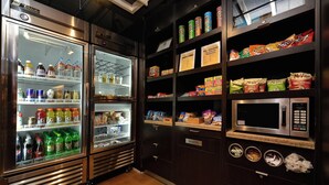A vending area with snacks, drinks, and a microwave. - Courtyard By Marriott Bentonville (Bentonville)