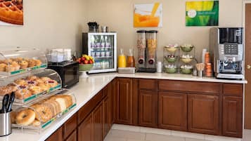 A breakfast buffet with various food items and a coffee machine.