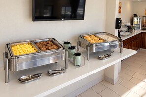 A buffet setup with various food items and serving utensils. - Quality Inn Winslow I-40 (Winslow)
