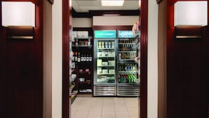 A guest market area with refrigerated display cases and shelves stocked with beverages and snacks. - HYATT house Denver Tech Center (Greenwood Village)